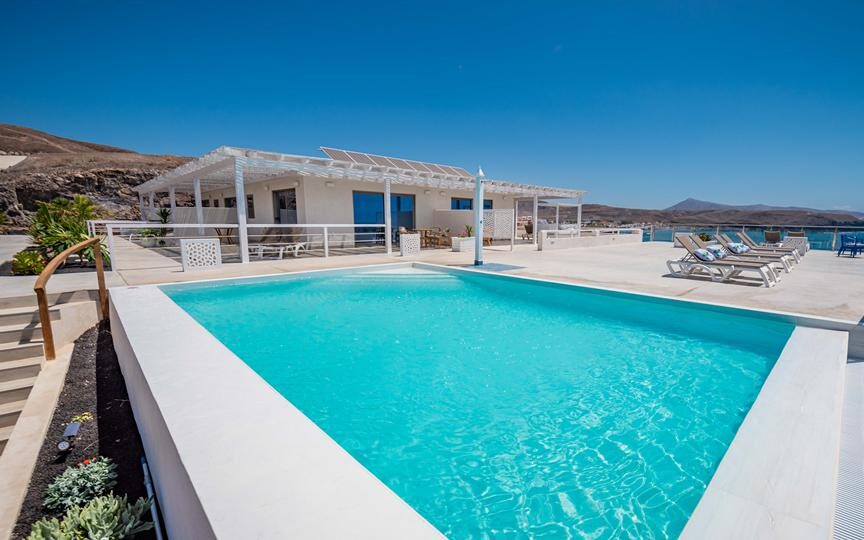 Geniet op een loungebedje aan het zwembad van het heerlijke uitzicht over zee vanaf Etti Paradise, een kleinschalig hotel op Fuerteventura voor volwassenen vanaf 18 jaar