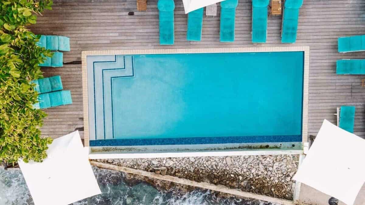 De perfecte kleinschalige vakantie op Curaçao: loungen aan het zwembad met uitzicht op zee bij de Scuba Lodge & Ocean Suites